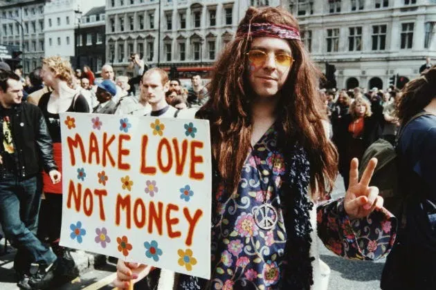 a hippy holding a sign that says make love not money